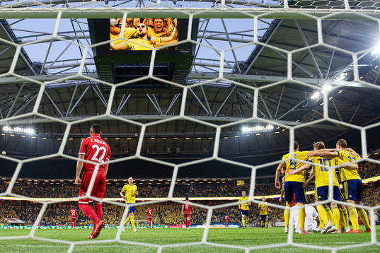 Zach Muscat of Malta looks dejected while Marcus Berg, Emil