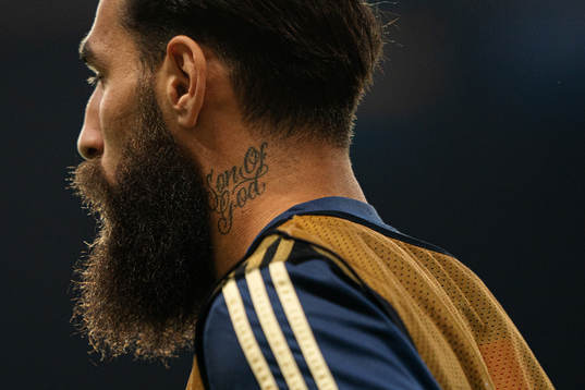Jimmy Durmaz of Sweden with a tattoo saying Son of God