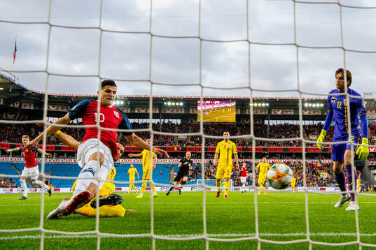 Tarik Elyounoussi of Norway scores 1-0 behind goalkeeper