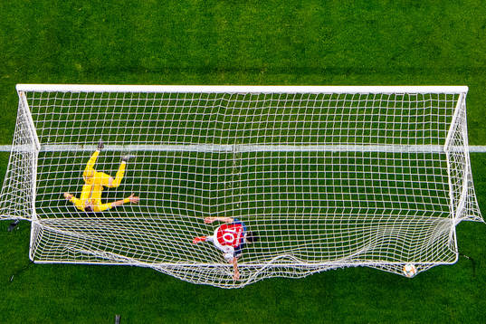 Tarik Elyounoussi scores 1-0 past Dragos Grigore of Romania