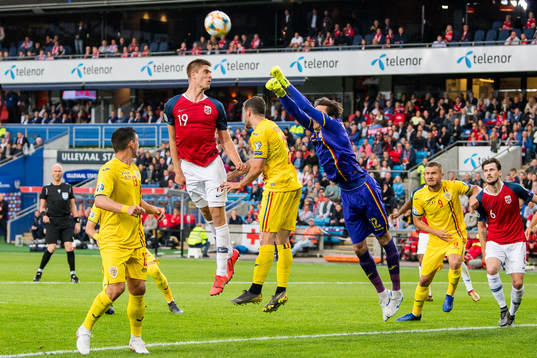 Markus Henriksen of Norway and goalkeeper Ciprian