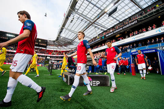 Martin Ødegaard and Tarik Elyounoussi of Norway enter the