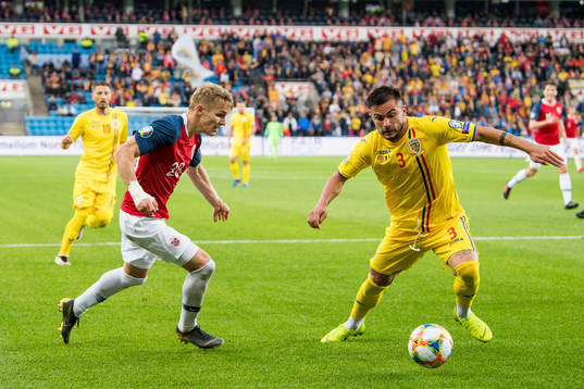 Martin Ødegaard of Norway and Alin Tosca of Romania