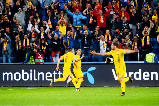 Claudiu Keseru of Romania celebrates with teammates