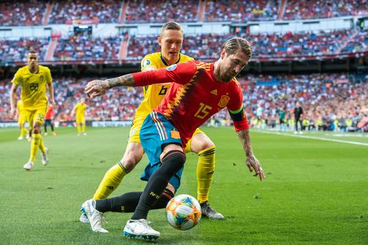 Ludwig Augustinsson of Sweden and Sergio Ramos of Spain
