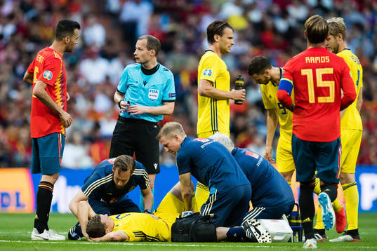 Viktor Claesson of Sweden receives help of the pitch