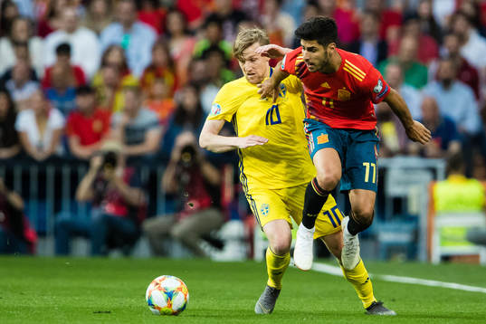 Emil Forsberg of Sweden and Marco Asensio of Spain competes