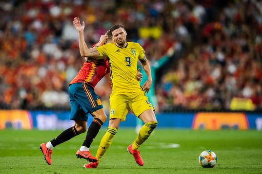 Inigo Martínez of Spain and Marcus Berg of Sweden
