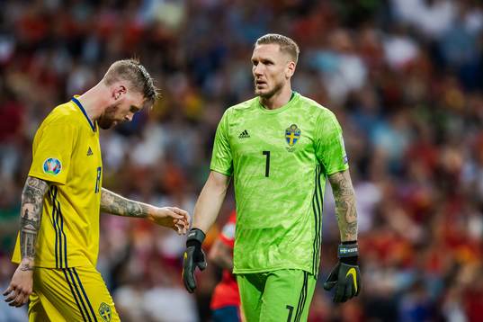 Pontus Jansson of Sweden and goalkeeper Robin Olsen of