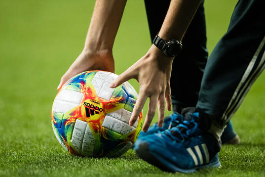 Two hands grab a ball