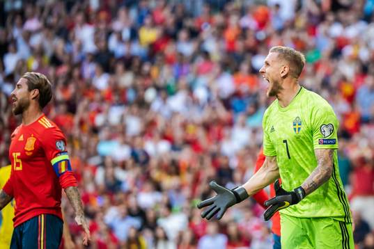 Sergio Ramos of Spain and goalkeeper Robin Olsen of Sweden