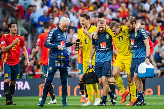 Viktor Claesson of Sweden receives help of the pitch