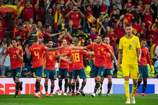 Mikael Lustig of Sweden looks dejected while Sergio Ramos