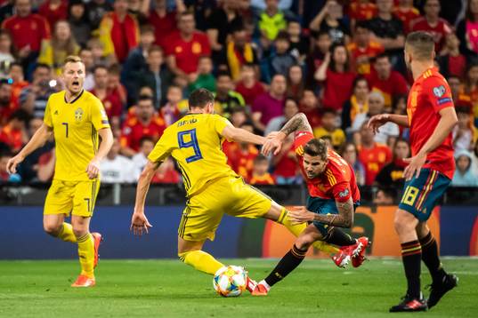 Marcus Berg of Sweden and Inigo Martínez of Spain
