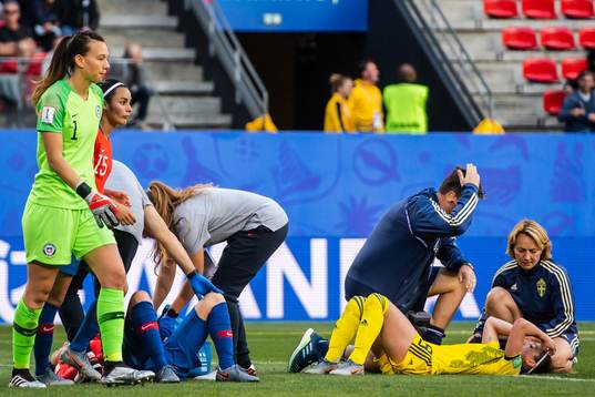 Kosovare Asllani of Sweden receives help