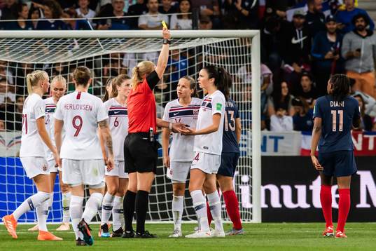 Ingrid Syrstad Engen of Norway is shown a yellow card by