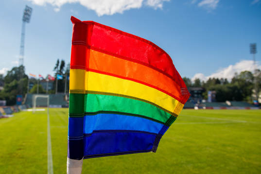 A rainbow-colored corner flag
