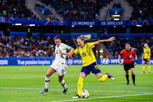 Carli Lloyd  of USA and Nathalie Björn of Sweden