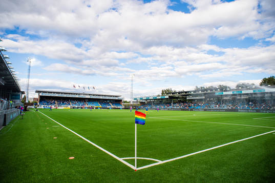 A rainbow-colored corner flag at Marienlyst Stadion