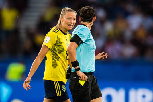 Fridolina Rolfö of Sweden gets a yellow card from Referee