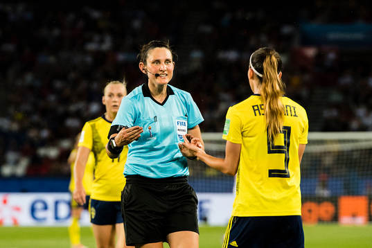 Referee Kate Jacewicz and Kosovare Asllani of Sweden