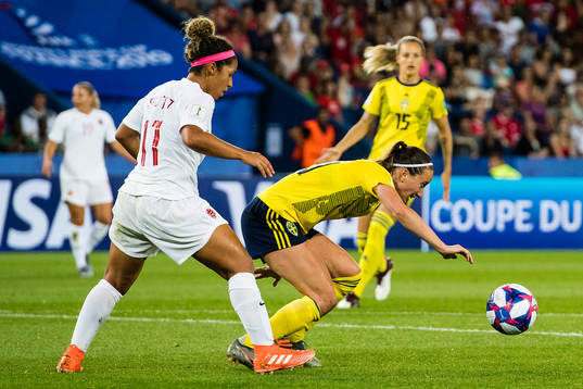 Desiree Scott of Canada and Kosovare Asllani of Sweden