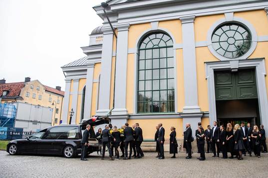 The coffin is carried out of the church