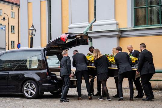 The coffin is carried out of the church