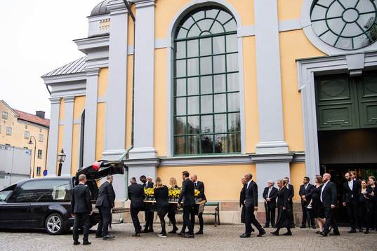 The coffin is carried out of the church