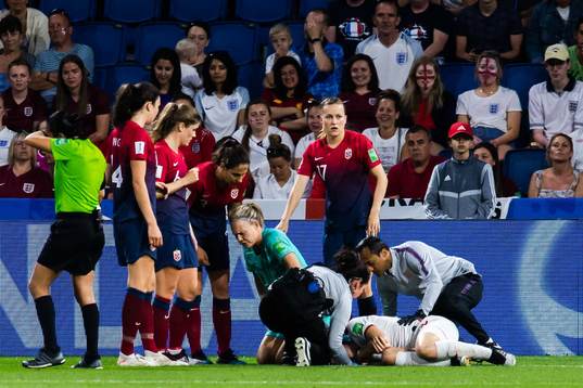 Goalkeeper Ingrid Hjelmseth of Norway receives medical