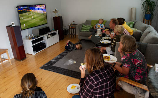 A family is watching the game