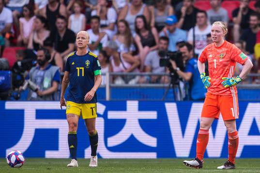 Caroline Seger and goalkeeper Hedvig Lindahl of Sweden look