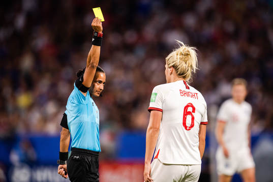 Millie Bright of England receives a yellow card