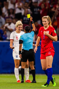 Millie Bright of England receives a yellow card