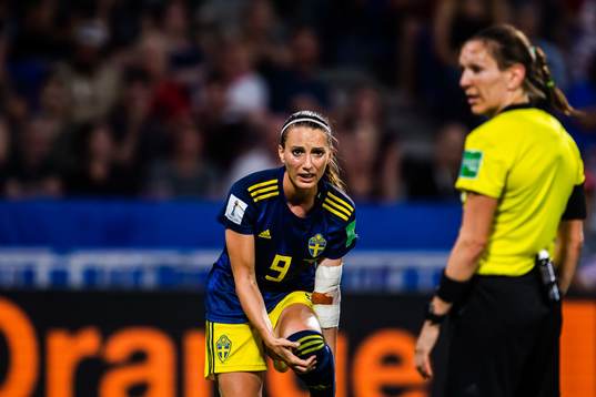 Kosovare Asllani of Sweden and eferee Marie-Soleil Beaudoin