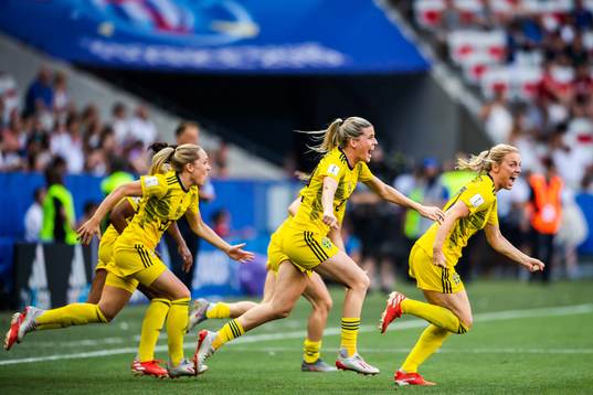 Substitutes of Sweden celebrate winning bronze