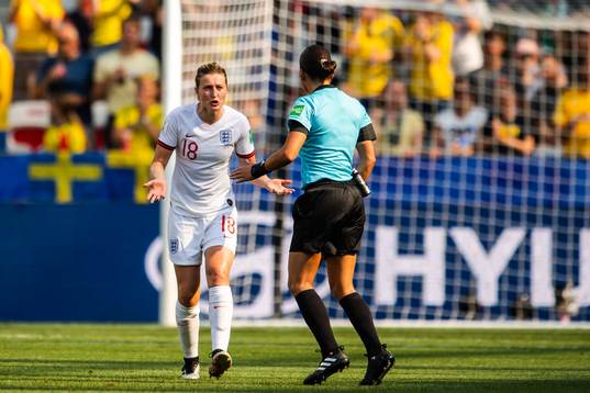 Ellen White of England in a discussion with Referee