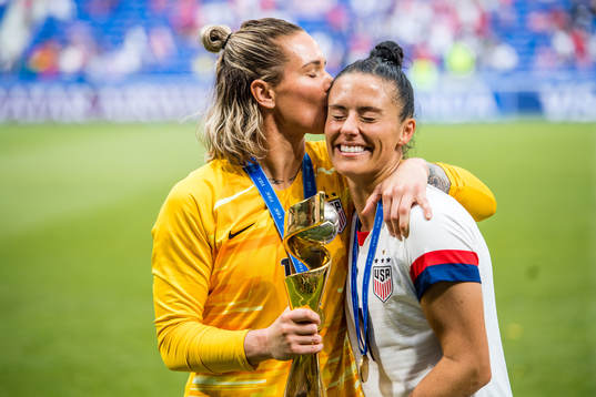 Ashlyn Harris and Tobin Heath of USA celebrates winning the
