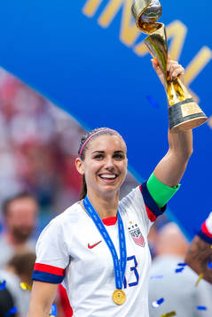 Alex Morgan of USA celebrates with the trophy
