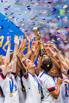 Alex Morgan of USA celebrates with the trophy