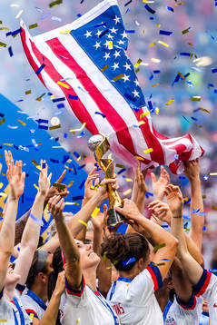 Alex Morgan of USA celebrates with the trophy