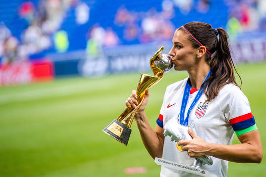 Alex Morgan of USA celebrates with the trophy