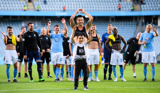 Behrang Safari of Malmö FF celebrate with a child