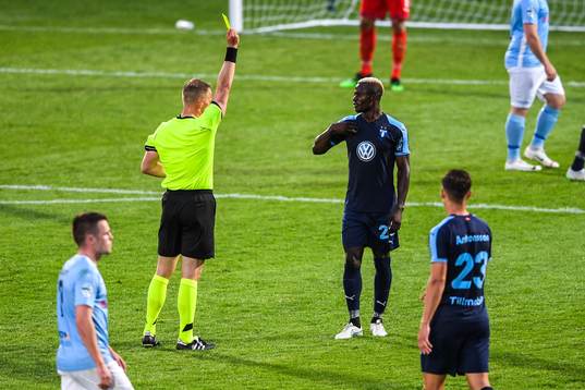 Bonke Innocent of Malmö FF is shown a yellow card by