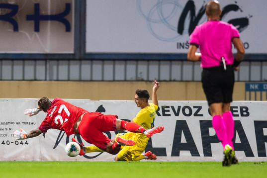Goalkeeper Johan Dahlin of Malmö FF saves an attempt from