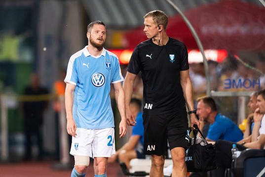Lasse Nielsen of Malmö FF leaves the pitch due to injury