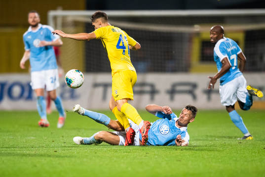 Markus Rosenberg of Malmö FF tackles Adam Gnezda of Domzale