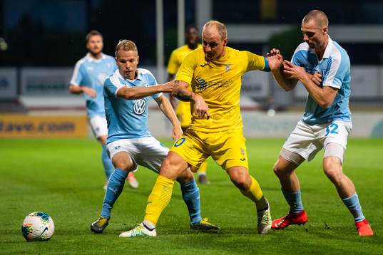 Oscar Lewicki and Jo Inge Berget of Malmö FF compete for