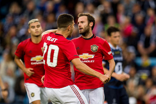 Juan Mata of Manchester United celebrates with teammates