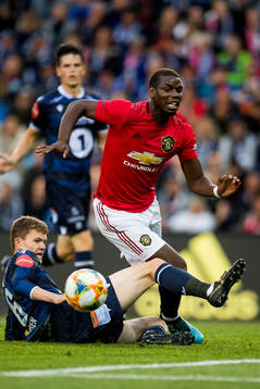 Meinhard Olsen of Kristiansund and Paul Pogba of Manchester